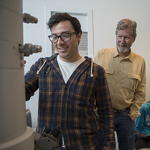 Professor Jan Factor works with a student on electron microscope