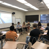 Students in the economics club sitting at desks in a classroom