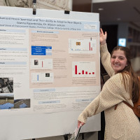 Gianna showing her poster at the NENHC in 2022
