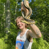 Robyn holding a snake in the Purchase Preserve