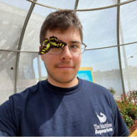 Jake Lupie with a butterfly at the Maritime Aquarium