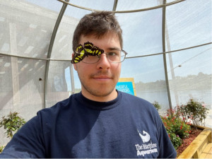 Jake Lupie with a butterfly at the Maritime Aquarium