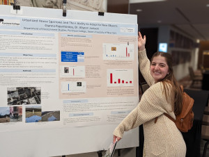 Gianna showing her poster at the NENHC in 2022