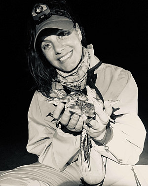 Veronica holding crocodile hatchlings during night survey in Florida bay