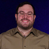 This is a picture of Jagger Vera, a Senior Stage Management Student, stand with his hands on his hips.