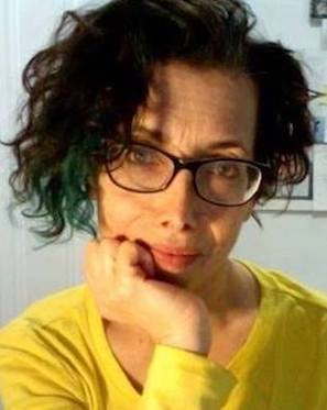 Judy Lieff (short dark curly hair surrounds a headshot of a caucasian woman with black square framed eyeglasses, dressed in a bright yell...