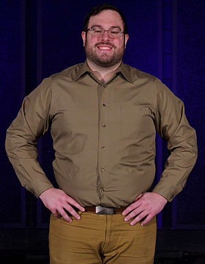 This is a picture of Jagger Vera, a Senior Stage Management Student, stand with his hands on his hips.