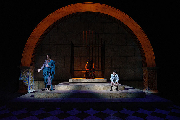 Plato narrates, Socrates in his cell in the background