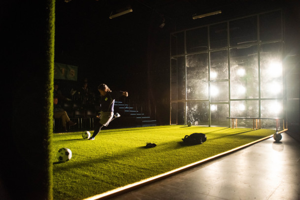 The WolvesSoccer Player kicking soccer ball at wall as she is illuminated by lights. Playwright: ...