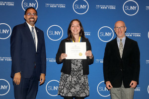 SUNY Chancellor John King, Hannah Kaebnick (holding a certificate), and Rudolf Gaudio, Director of Natural and Social Sciences