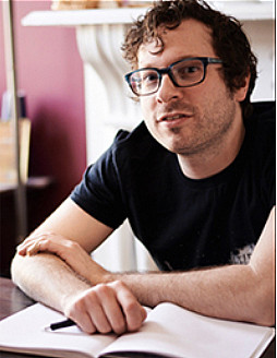 Ben Janse wearing black tshirt and dark rimmed glasses