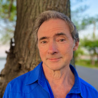 Professor Casey Haskin headshot with tree in background