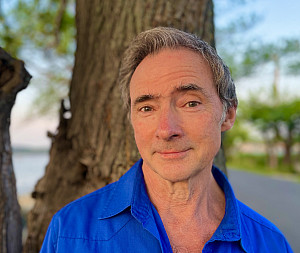 Professor Casey Haskin headshot with tree in background