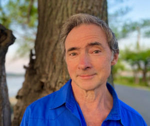 Professor Casey Haskin headshot with tree in background