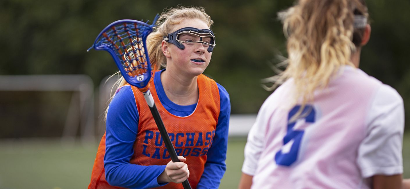 Purchase Lacrosse player holding lacrosse stick during a game