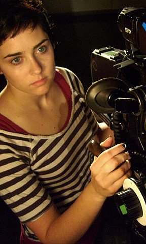 emily with 16mm camera Student in striped shirt holding a camera
