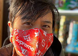 Image of Mark Ramos wearing a red Supreme face mask