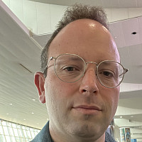 Professor Brian Maston wearing glasses and denin jacket