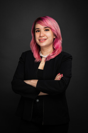 Melissa Rodriguez photo with pink hair and black sweater.