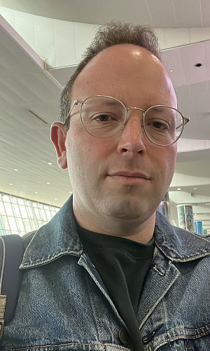 Professor Brian Maston wearing glasses and denin jacket