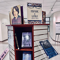 Display shelf with a sign reading Hispanic & Latinx Heritage Month on the top. The display in...