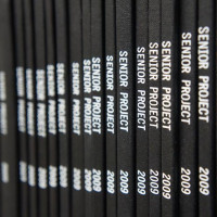 Spines of bound senior projects in the library's physical archive