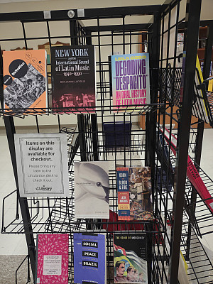 Black wire book display containing books relevant to Hispanic and Latinx Heritage Month