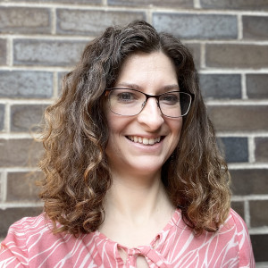 Portrait of Darcy Gervasio in front of a brick wall at Purchase College