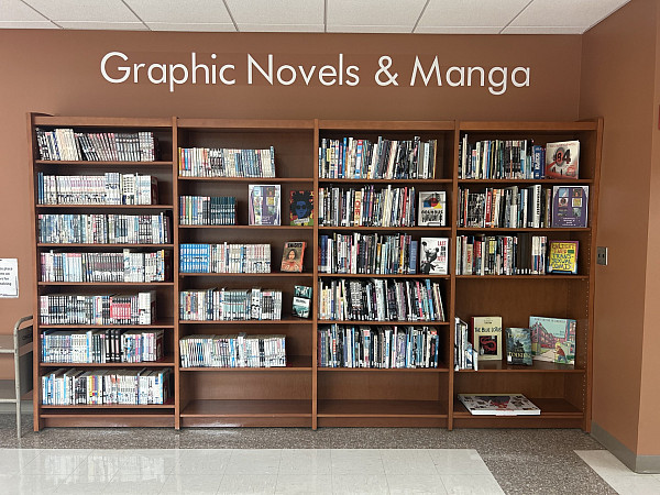 Manga, comics, and graphic novels on four tall shelves