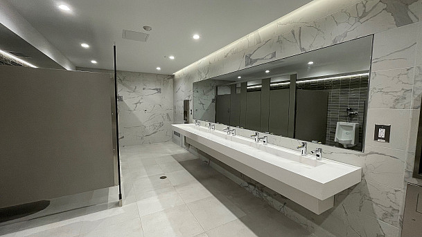 View inside new Men's restroom in Phy Ed looking at sinks.