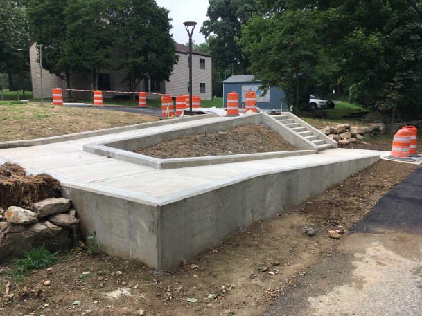 View of new concrete stairs & ramp under construction near The Commons.