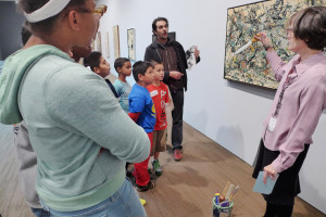 Docent Nancy Drain explains Jackson Pollock's painting techniques to kids from the Don Bosco ...