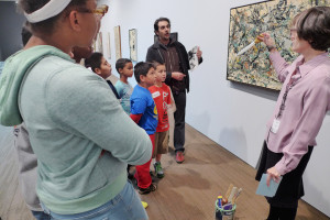 Docent Nancy Drain explains Jackson Pollock's painting techniques to kids from the Don Bosco center and to Leandro Benmergui, director of...