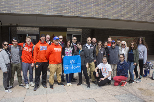 Students at Yards for Yeardley on the plaza hold One Love banner